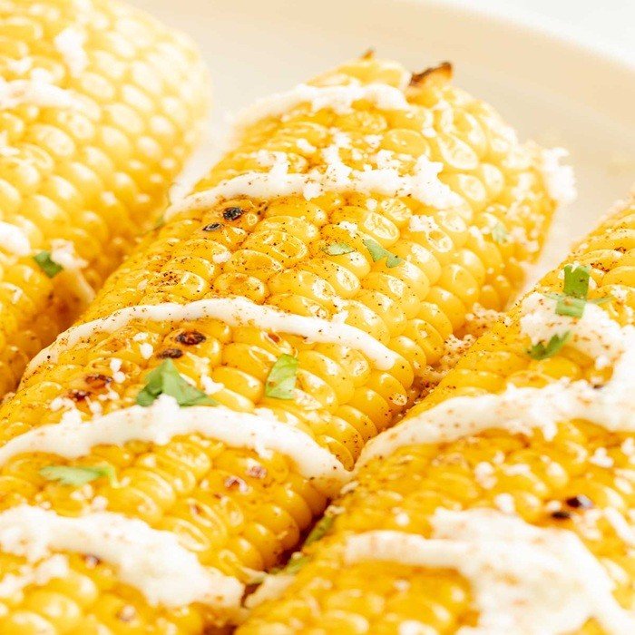 Grilled corn with garlic mayo & grated cheese