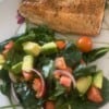 Salmon recipe with spinach, tomatoes and avocado salad